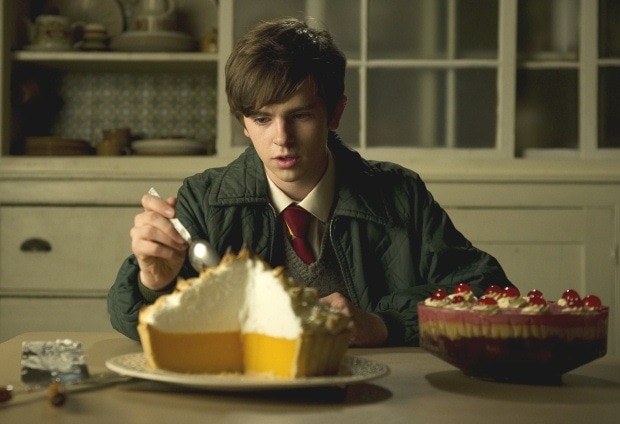 A still from Toast movie of Freddie Highmore eating lemon meringue pie.