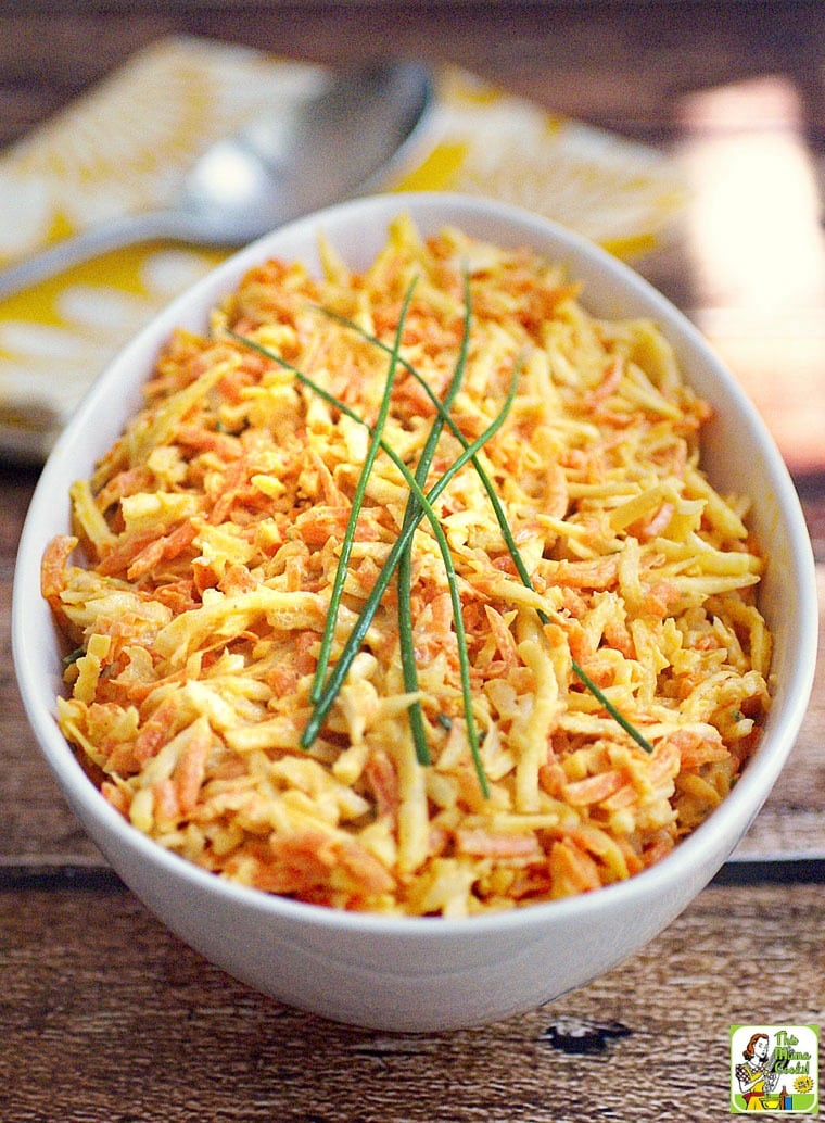 Closeup of a white bowl of Celery Root and Carrot Coleslaw.