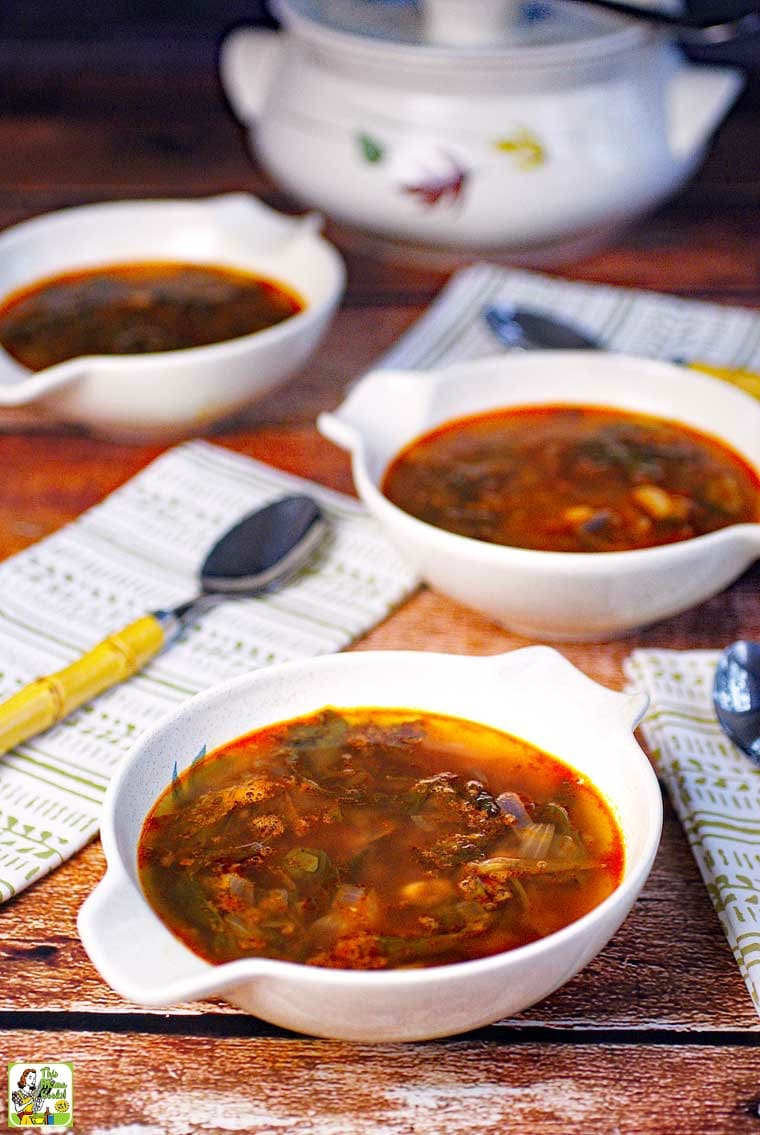 Bowls of Kale Soup with spoons and napkins