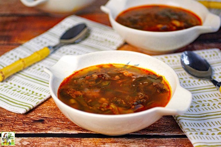 Bowls of Kale Soup with bamboo spoons and green print napkins