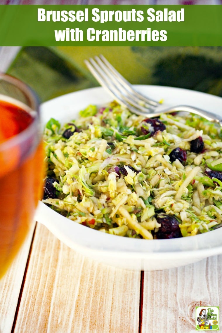 Closeup of a bowl of brussel sprouts salad with cranberries and a fork.