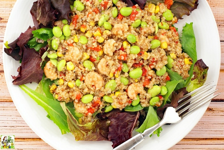 A white plate of Quinoa and Shrimp Salad with fork.