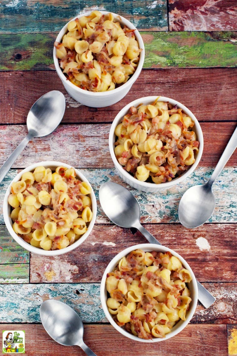 White ramekins of mac and cheese and silver spoons.