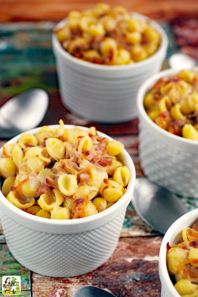 Closeup of White Ramekins of Gluten Free Mac & Cheese Casserole with Silver Spoons.