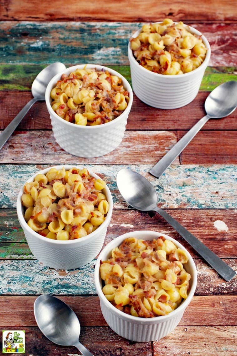 White Bowls of Macaronia and Cheese Casserole with Silver Spoons.