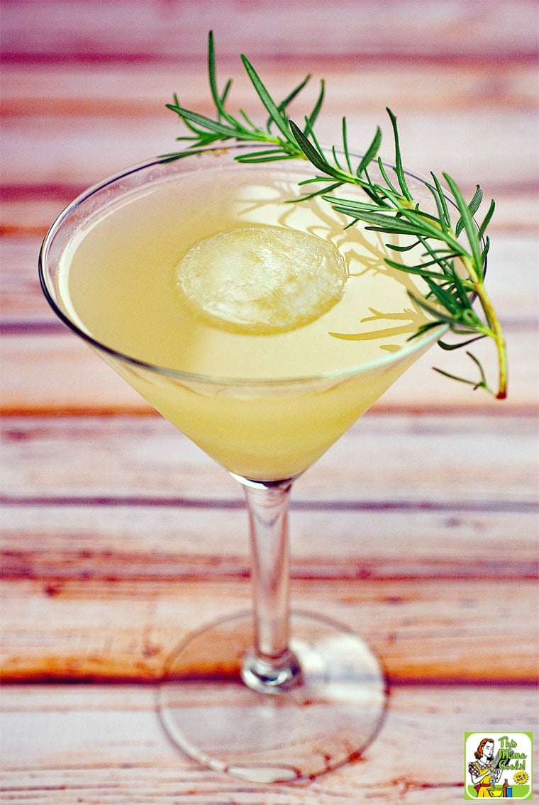White wine cocktail with sprig of rosemary.