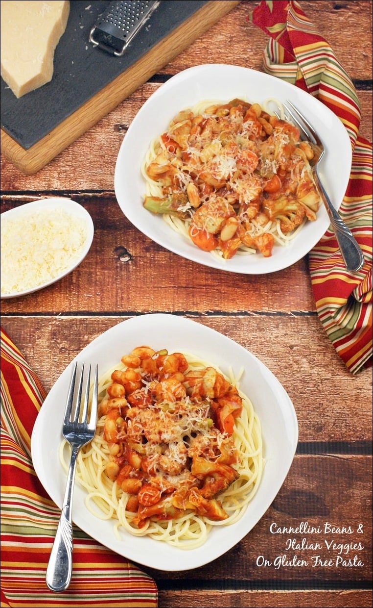 Overhead view of Bowls of Pasta Recipe with Cannellini Beans & Italian Veggies with napkins and forks.