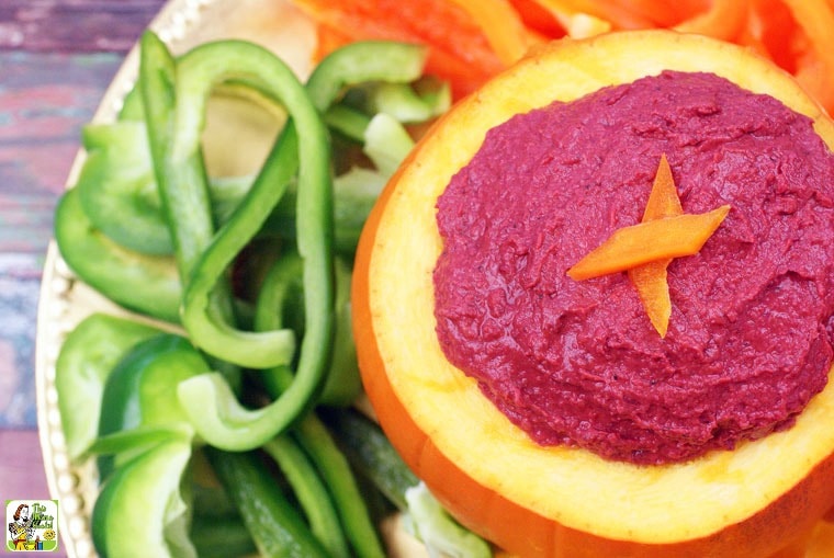 Plates of sliced peppers served with Cranberry Hummus.