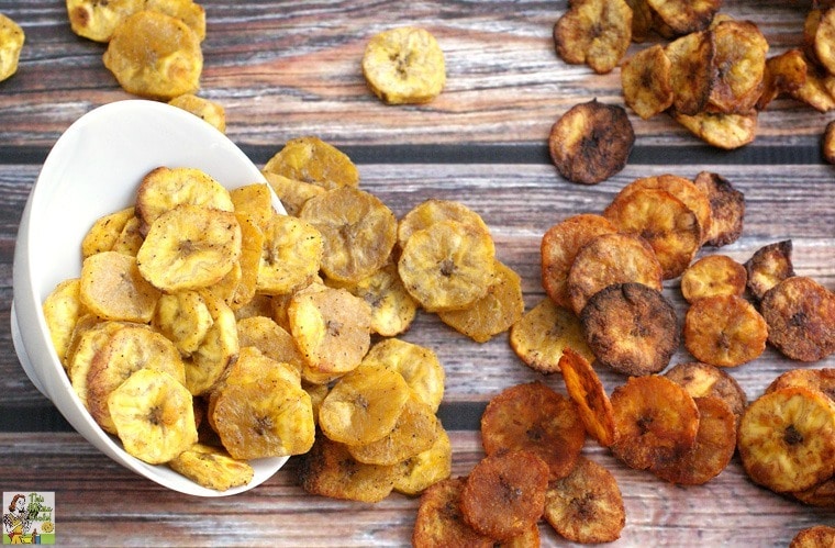 Oven baked plantain chips spilling out of a white bowl.