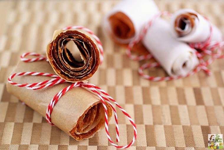Orange Fruit Leather rolls in parchment and tied with string.