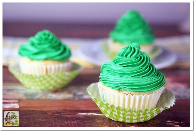 Three filled cupcakes with green icing.
