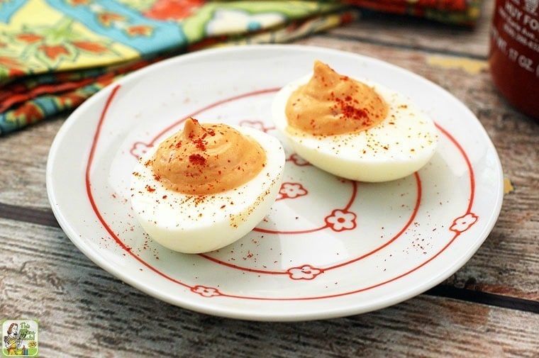 A plate of keto deviled eggs with multicolored napkin.