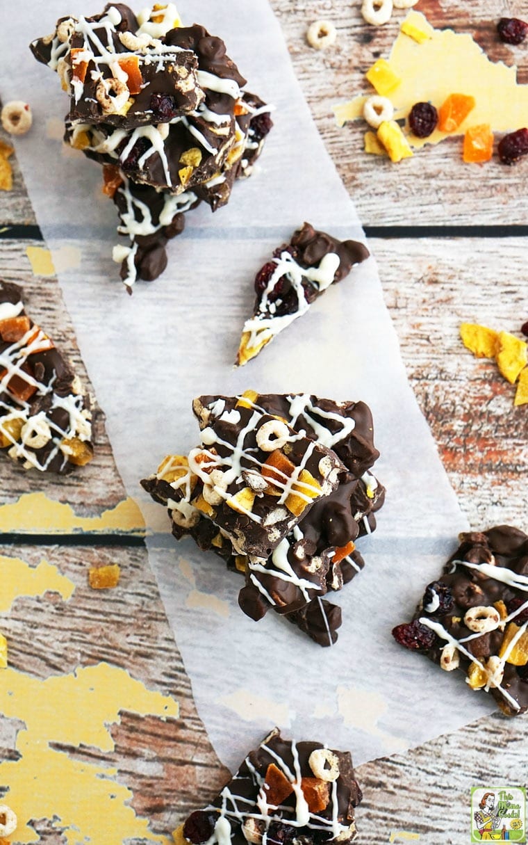 Stacks of chocolate bark with dried fruit and cheerios.