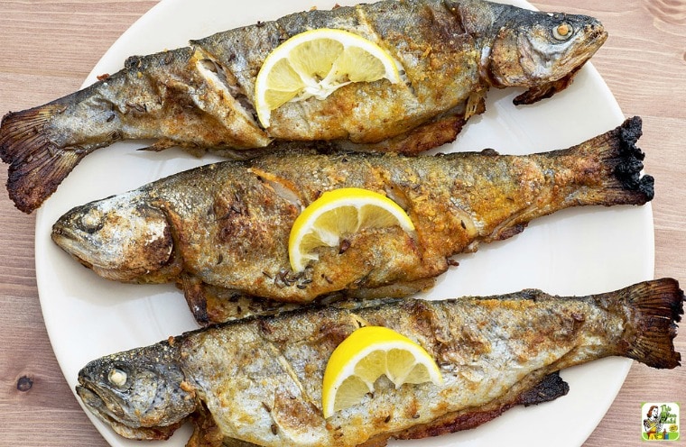 Smoked Trout on a plate with lemon slices.