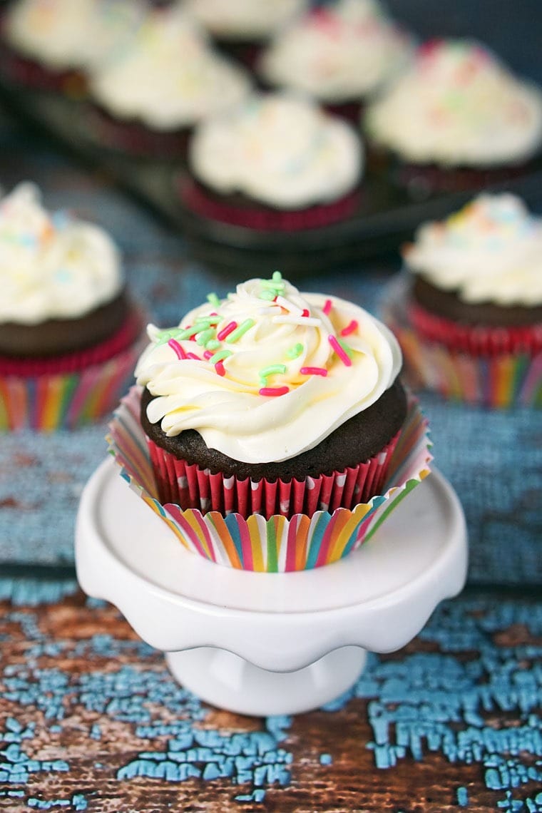 Closeup of a Cookie Dough Stuffed Cupcake on a mini cake stand.