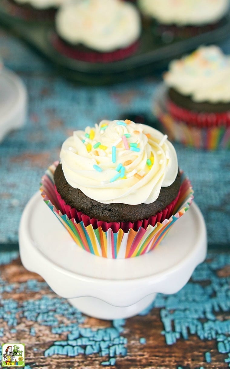 Closeup of a frosted Cookie Dough Stuffed Cupcakeson a mini cakestand.