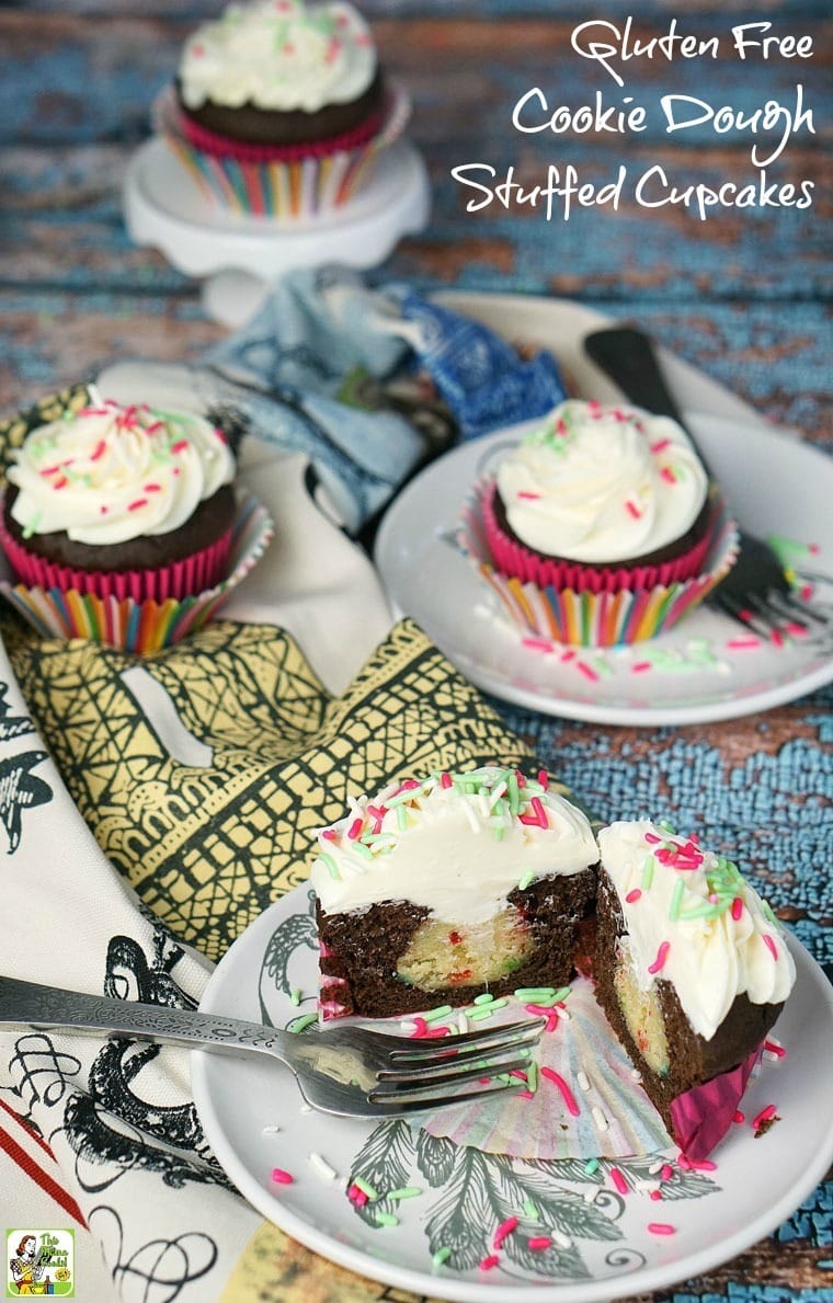 Cookie Dough Stuffed Cupcake on a plates, kitchen towels, and mini cake stands.