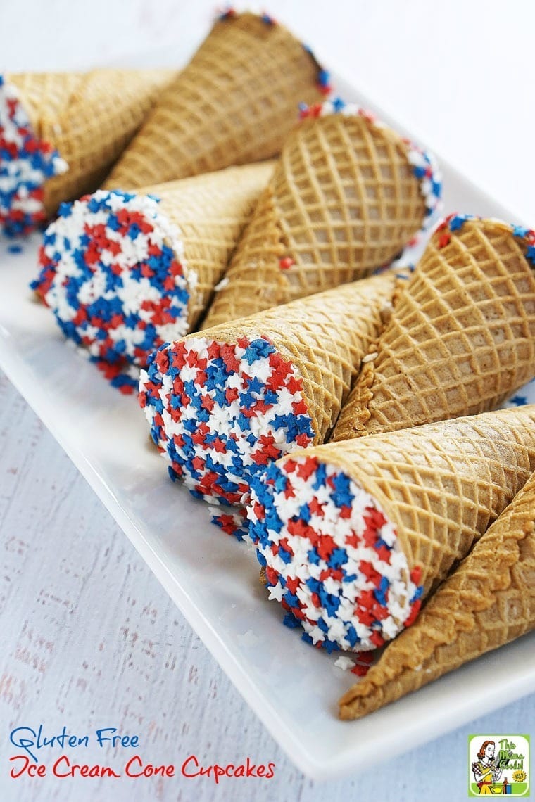 A serving plate of Ice Cream Cones Cupcakes with red white and blue star shaped sprinkles.