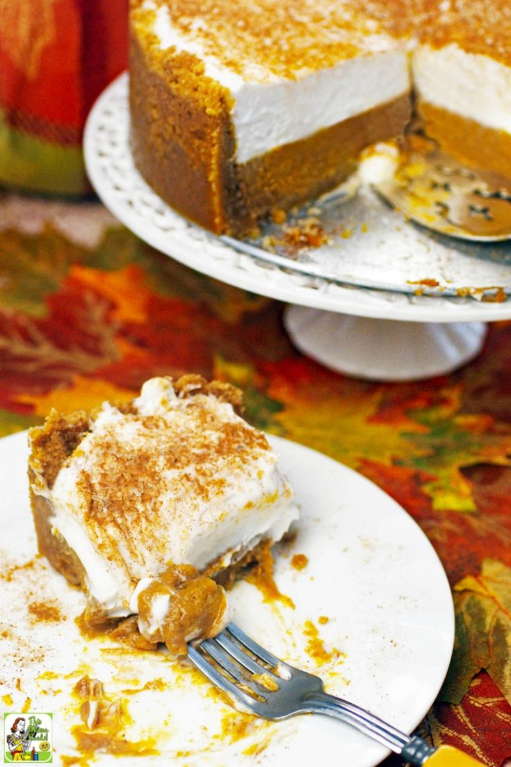 Slice of a gluten free dairy free pumpkin pie on a white plate. Deep dish pumpkin pie on a white pie stand.