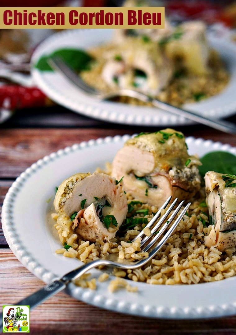 A plate of Chicken Cordon Bleu served on rice on a white plate with a silver fork.