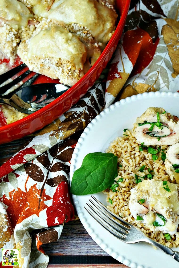 A platter and plate of chicken cordon bleu with colorful napkins. 