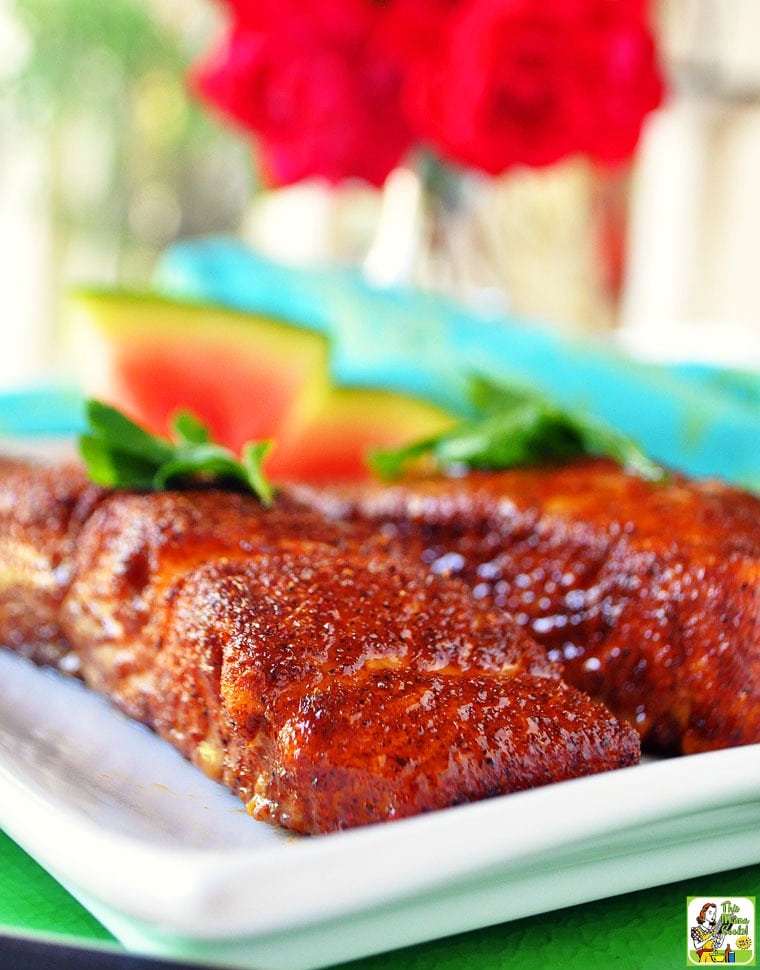 Oven baked salmon with a brown sugar glaze on a white plate.