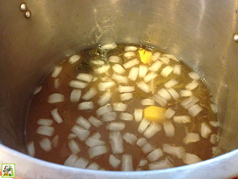 Cooling down the pot of smoked turkey breast brine with ice cubes.