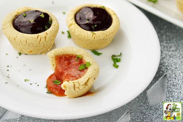 Three Fruit Filled Cookie Cups on a white plate with mint garnish.