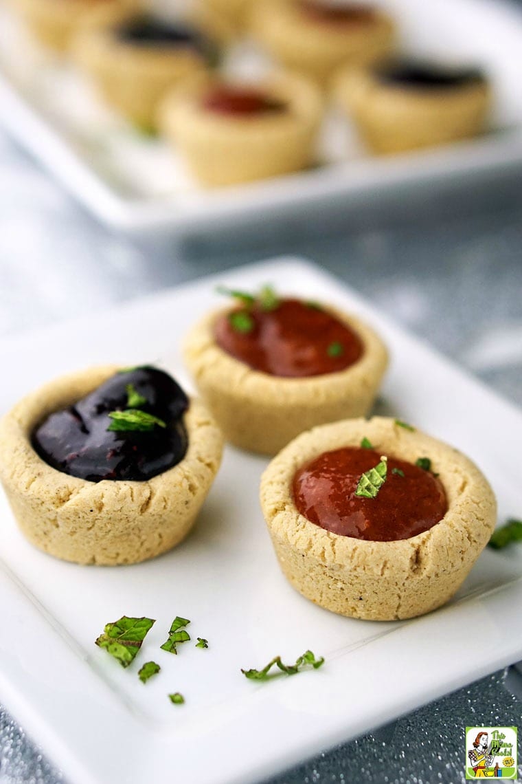 Cherry and peach fruit Filled Cookie Cups on a square white plate with mint garnish.
