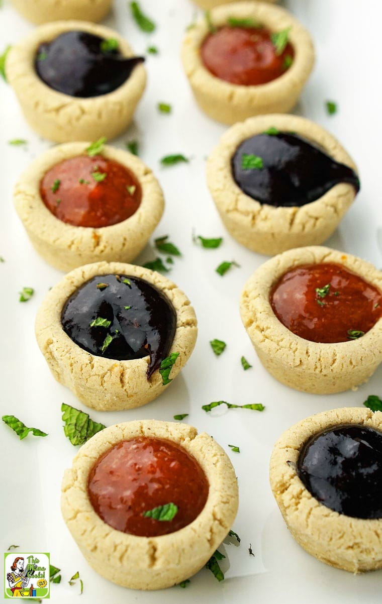 A long white tray of cherry and peach fruit filled cookie cups.