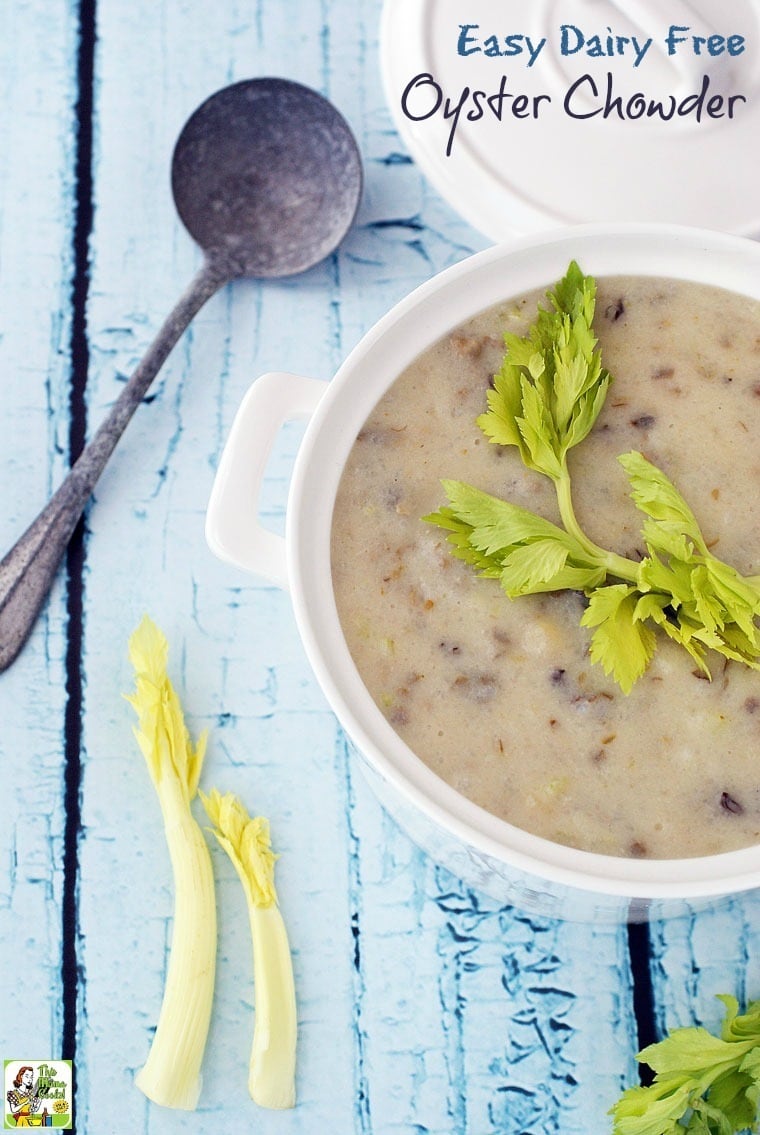 Closeup of A bowl of Easy Dairy Free Oyster Chowder with lid, celery stalks, and ladle.