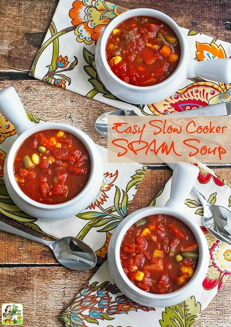 Overhead shot of bowls of spam soup with colorful floral napkins and spoons.