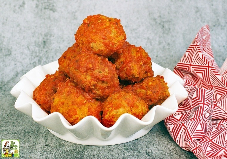 A pile of Slow Cooker Turkey Meatballs in a white bowl with a red and white napkin.