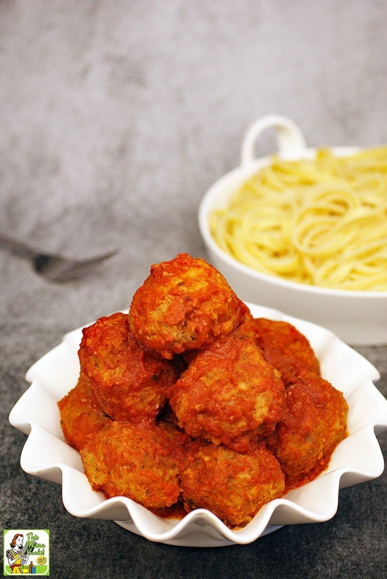 Closeup of a bowl of Slow Cooker Turkey Meatballs with a bowl of pasta in the background.
