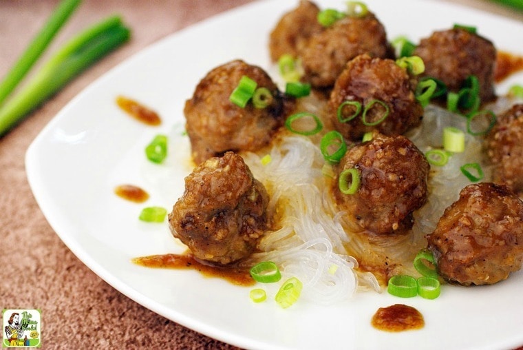 Gluten Free Asian Meatballs with Hoisin Sauce on a white plate with chopped green onions.