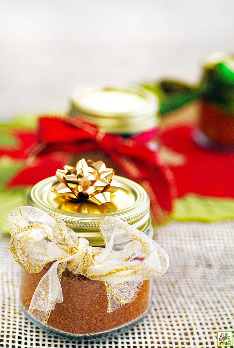 Jars of homemade taco seasoning with festive ribbons and bows.