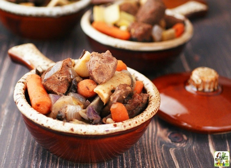 Bowls of slow cooker venison stew on a tabletop.