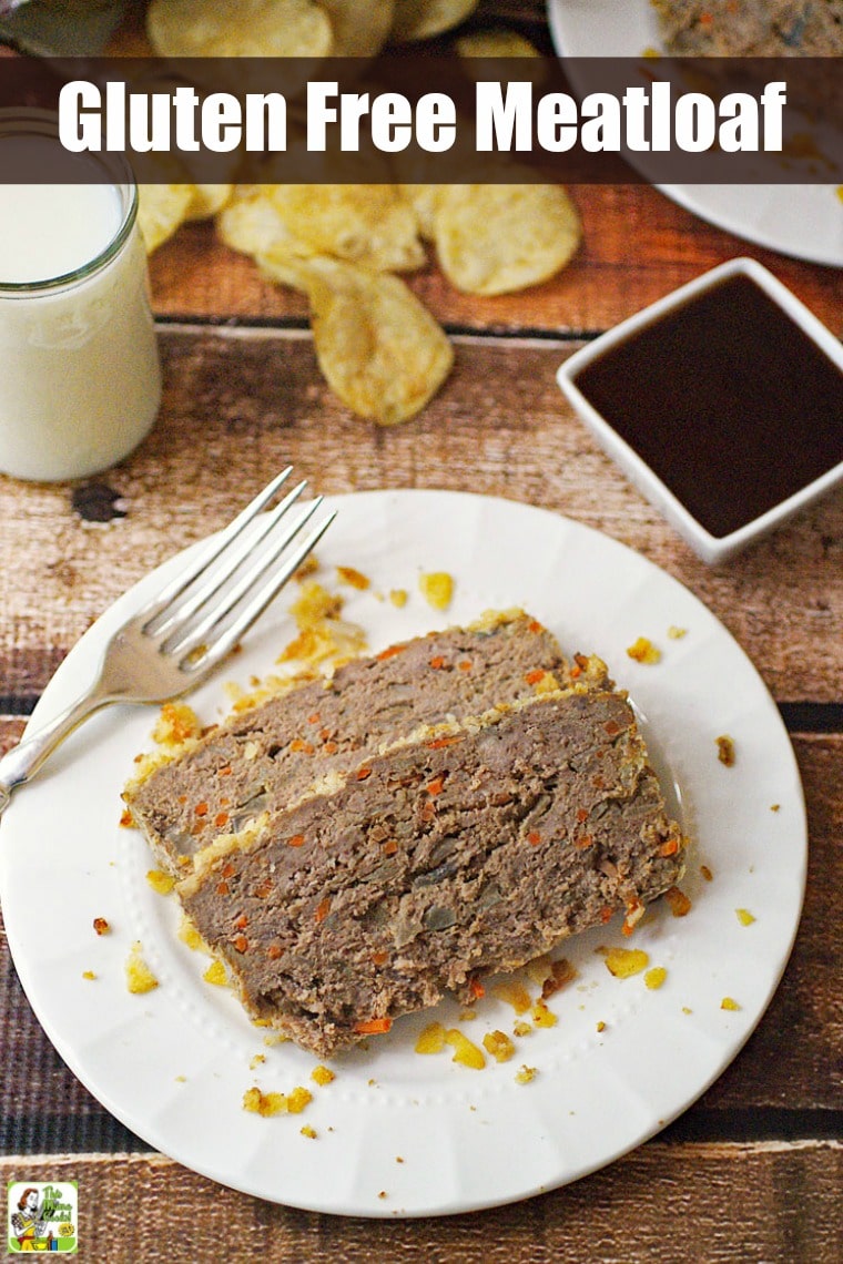 Meatloaf with Potato Chips & Carrots on a white plate with glass of milk and dish of BBQ sauce.