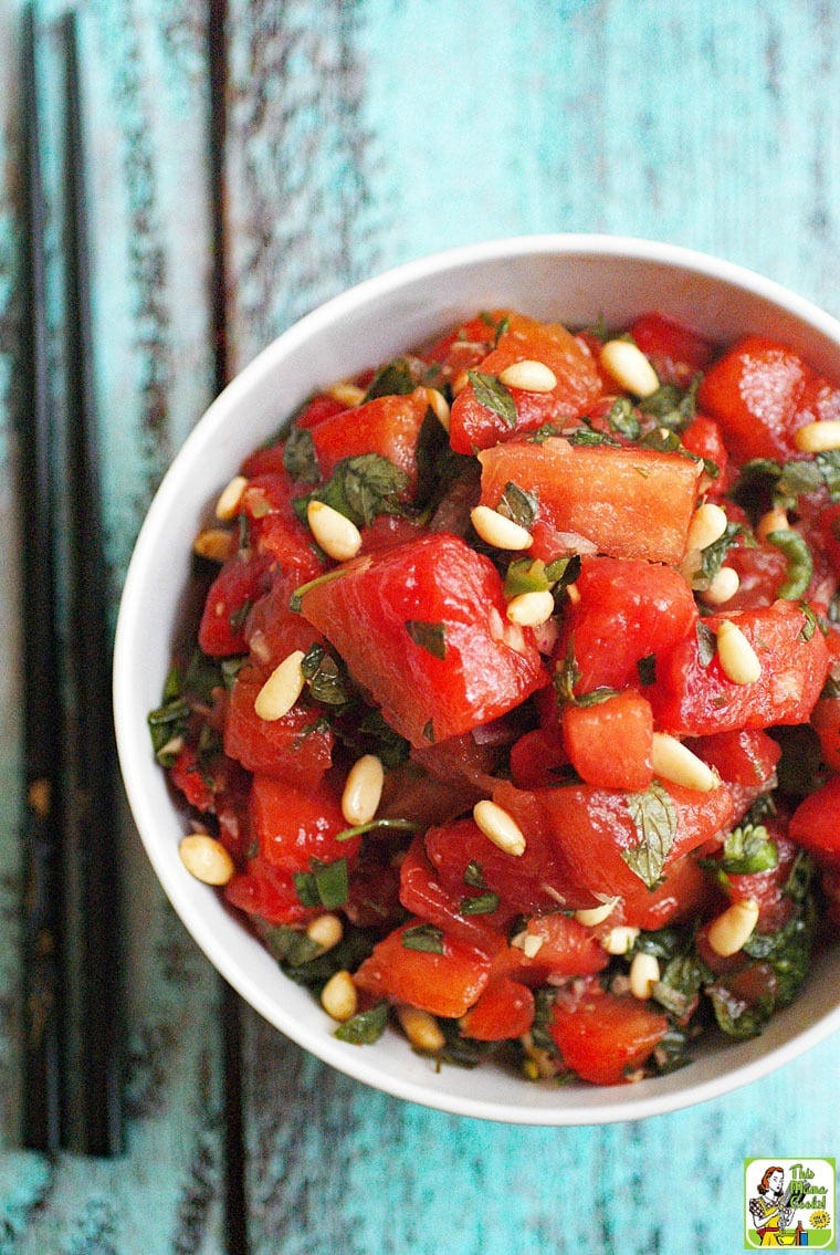 A bowl of Asian Watermelon Fruit Salad made with basil, mint, cilantro and pine nuts.
