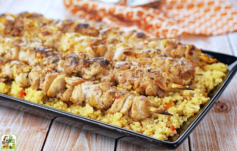 Easy Chicken Skewers with Orange Quinoa on a black platter.