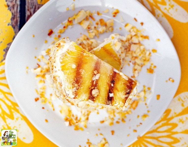 Tropical Ice Cream Sandwich made with pineapple slices and toasted coconut on a plate.