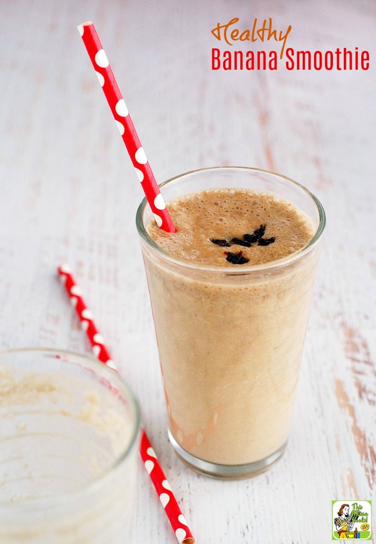 A tall glass of banana smoothie with a red straw.
