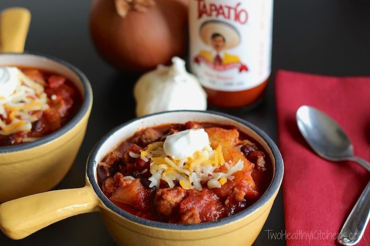 Bowls of Crock-Pot Crazy Pineapple Chili with spoon and napkin.