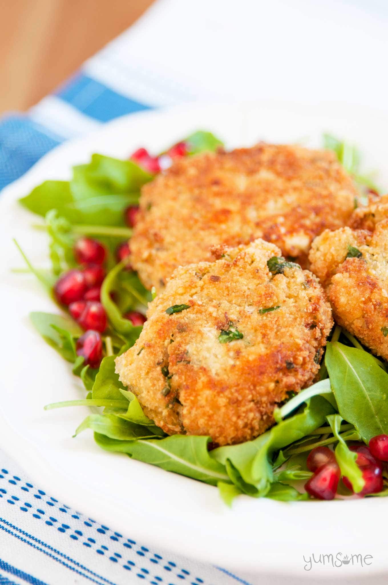 A plate of Easy Vegan Quinoa and Cheese Patties on lettuce leaves.