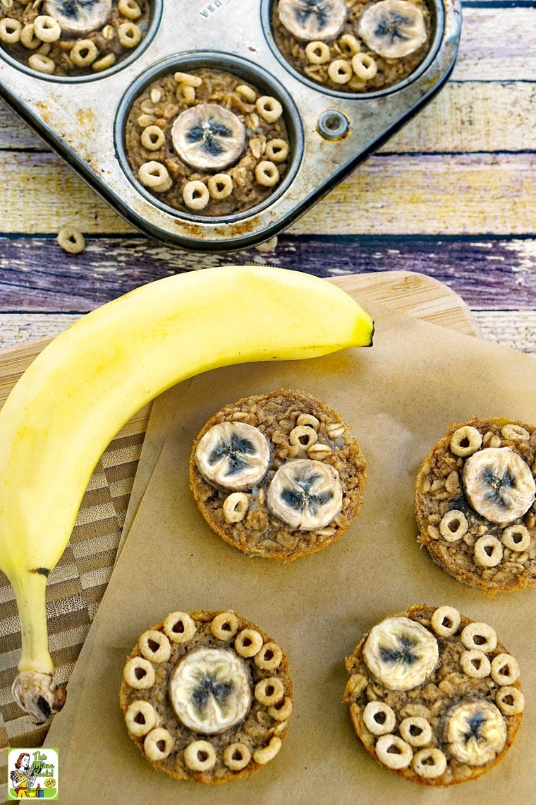 Gluten free banana muffins on a white plate and on cutting board with parchment paper.