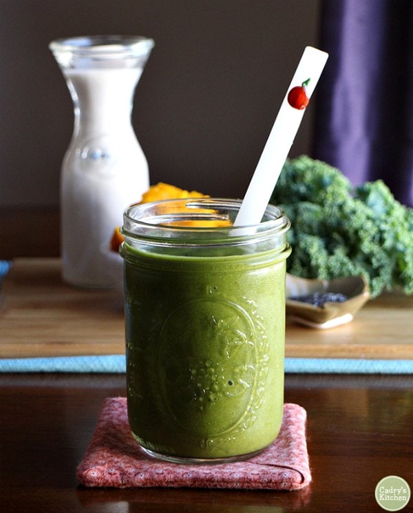 Green Pumpkin Smoothie served in a canning jar with a straw.