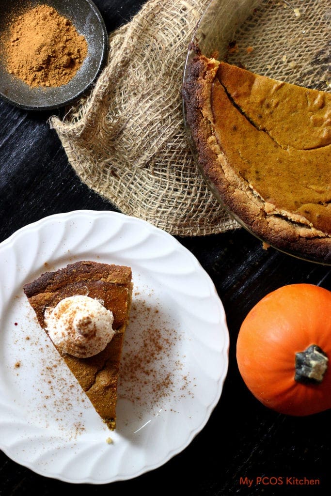 A plate of Paleo Pumpkin Pie and whole pie on a piece of burlap.