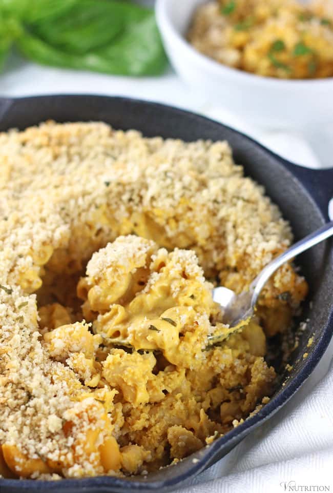 Baked Vegan Pumpkin Mac and Cheese served in a cast iron skillet.