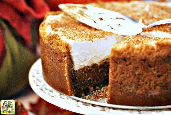 Gluten Free Dairy Free Pumpkin Pie with serving knife on a cake stand.