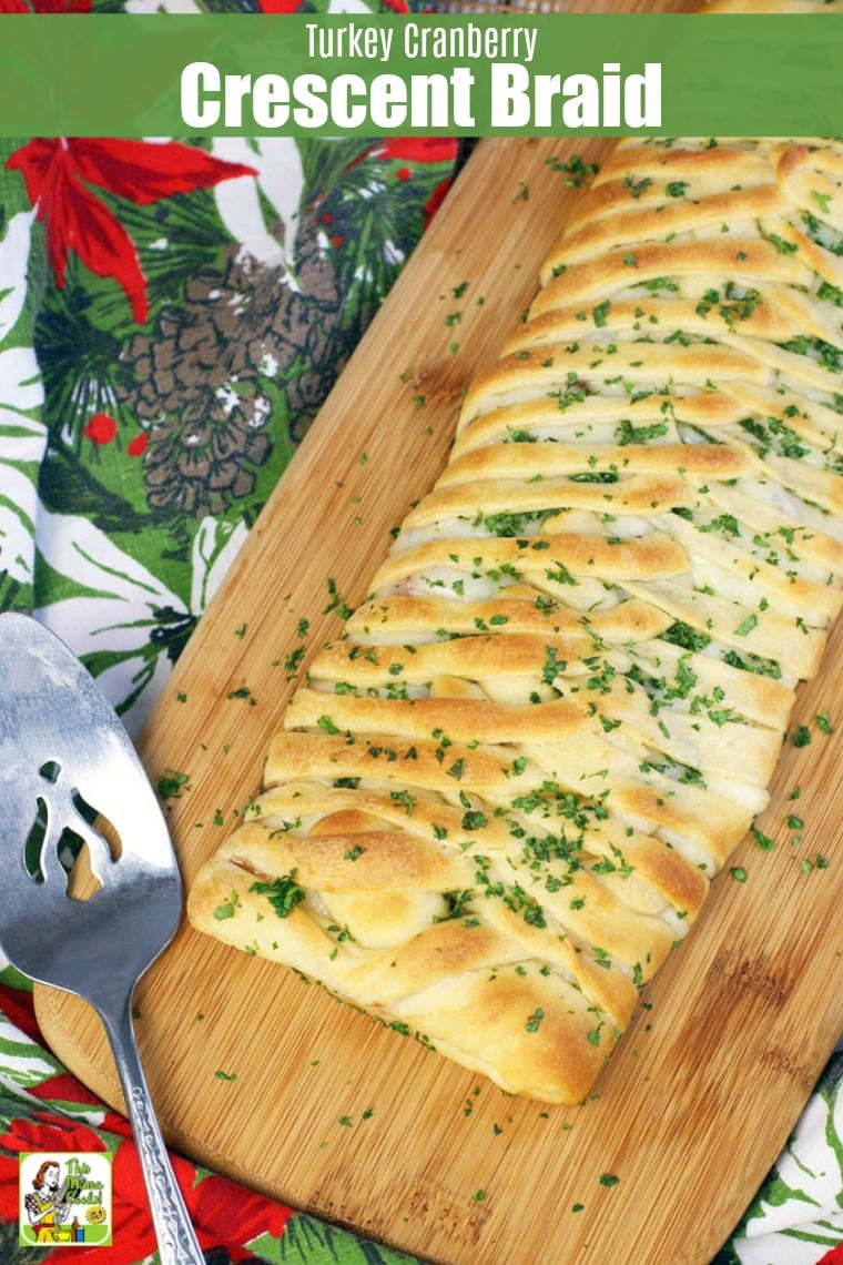 Turkey Cranberry Crescent Braid on a cutting board with a serving knife.